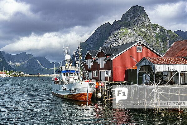 Rorbuer  typische Holzhäuser  Fischerboot im Hafen  Reine  Moskenesöy  Lofoten  Nordland  Norwegen  Europa