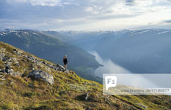 Hiker at the top of Mount Prest  Aurlandsfjord  Aurland  Norway  Europe