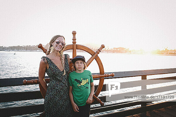 Mother and Son Stand Next to a Helm on a Santa Barbara Dock at Sunset