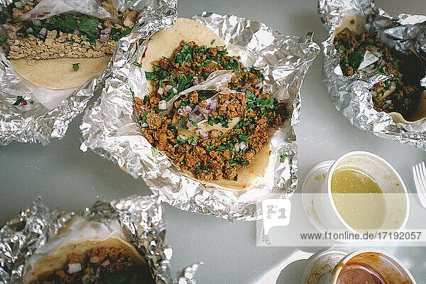 Street Style Tacos with Assorted salsas in tinfoil