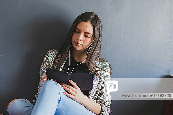 Junge Frau liest ein elektronisches Buch.