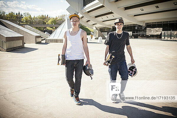 Skateboarders outside on sunny day hanging out