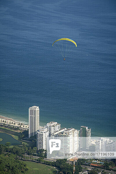 Beautiful view to paraglider flying over residential buildings