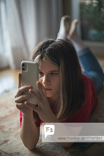 Ein junges Mädchen schaut auf den Bildschirm ihres Smartphones