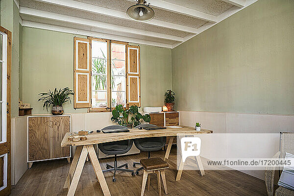 Empty office with chairs and wooden table at workshop