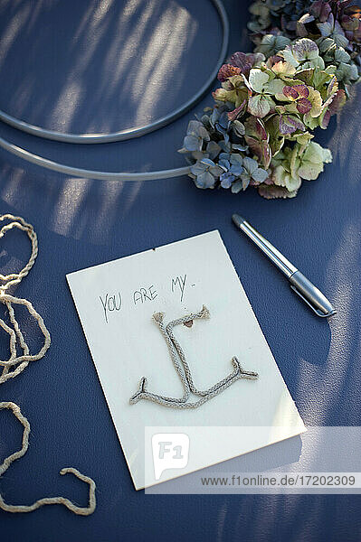 Greeting card with anchor made of piece of string