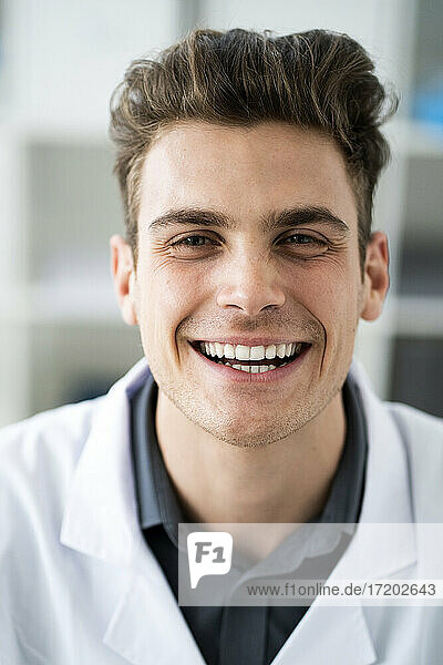 Male scientist smiling in laboratory