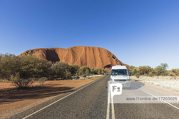 Australia  Northern Territory  Road through desert landscape with Uluru
