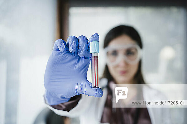 Blood sample held by female doctor in hospital