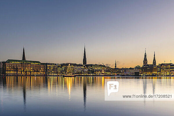 Germany  Hamburg  City architecture reflecting in Binnenalster lake at dusk