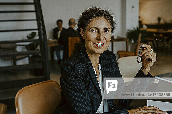 Portrait of businesswoman smiling while sitting in office