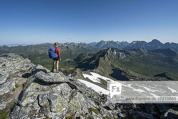 Hiker on the trail to the mountain Rundfjellet  Lofoten  Nordland  Norway  Europe