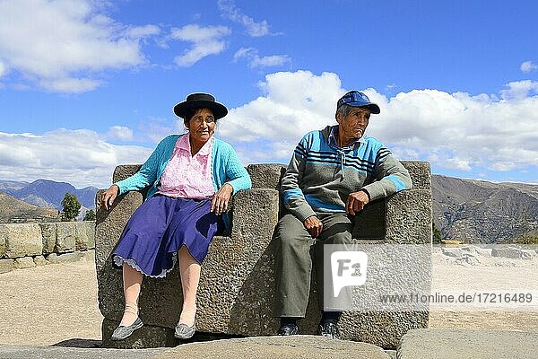 Old indigenous couple sitting on the throne of the Inca on the pyramid  Ushnu  Vilcashuamán  Ayacucho region  Peru  South America