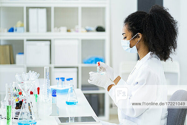 Junge Forscherin bei einem wissenschaftlichen Experiment im Labor während einer Pandemie
