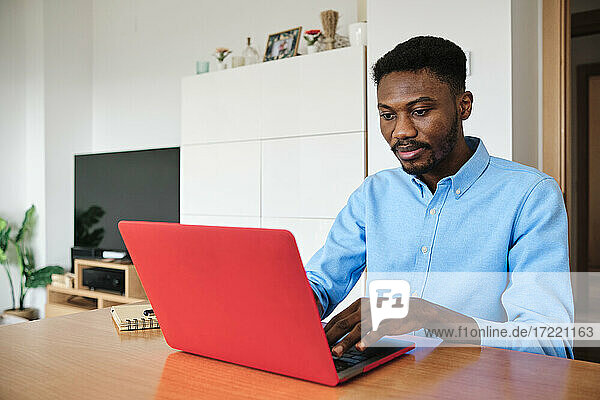 Mittelgroßer Unternehmer arbeitet zu Hause am Laptop