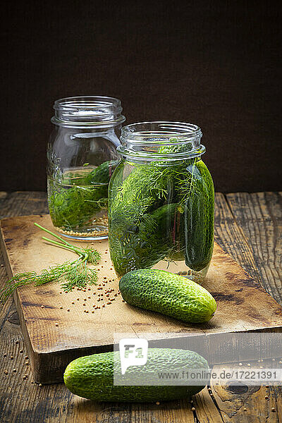 Pickled gherkins in jar with mustard seeds and dill