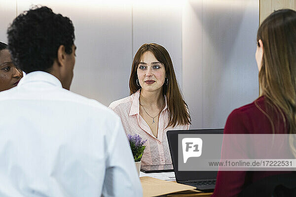 Male and female colleagues in meeting at office