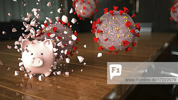 Coronavirus zerbricht Sparschwein auf Konferenztisch im Büro