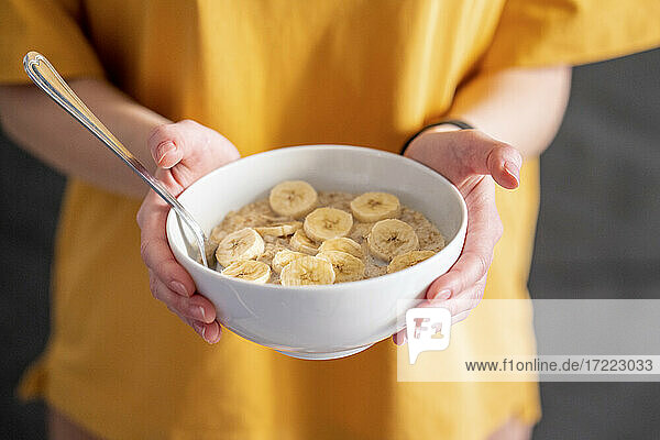 Woman holding breakfast bowl at home