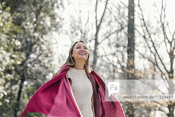 Cheerful woman smiling during sunny day