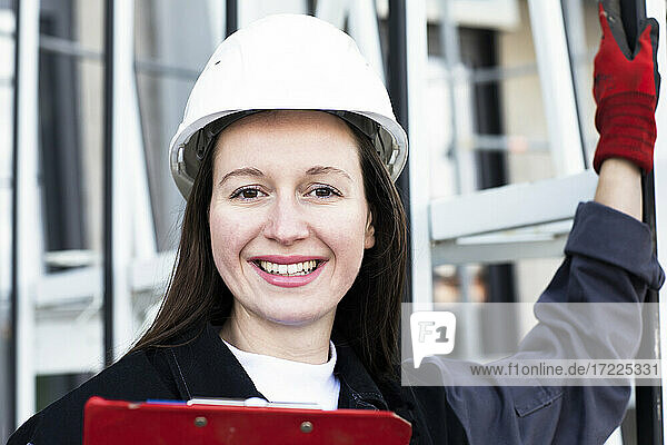 Smiling female engineer at construction site