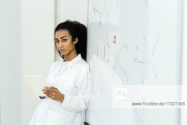 Young female researcher with digital tablet in laboratory