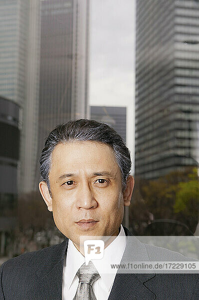 Portrait confident businessman in city