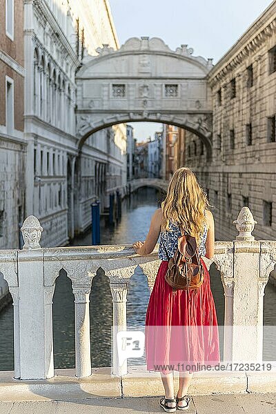 Young woman with red skirt  tourist looking towards the Bridge of Sighs  Venice  Veneto  Italy  Europe