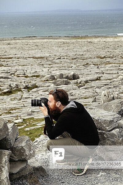 Man taking photograph  The Burren  County Clare  Ireland