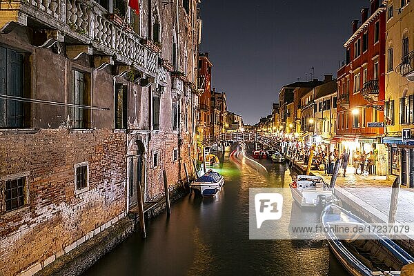 Evening atmosphere  streetlights  canal with boats and historical buildings  light traces  Venice  Veneto  Italy  Europe