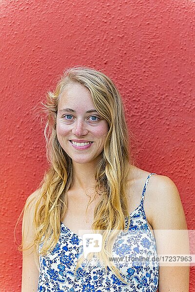 Portrait of a Young Woman in Front of a Red Wall  Burano Island  Venice  Veneto  Italy  Europe
