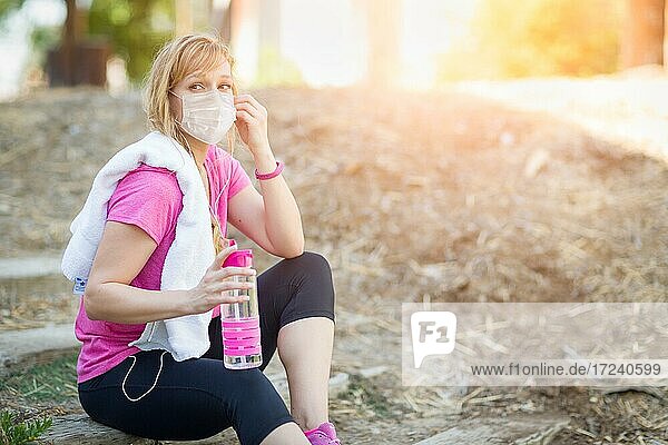 Girl wearing medical face mask during workout outdoors