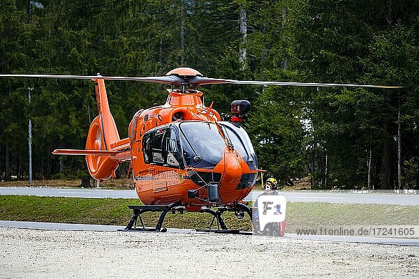 A flight rescuer of the Bergwacht Bayern kneels next to the rescue ...