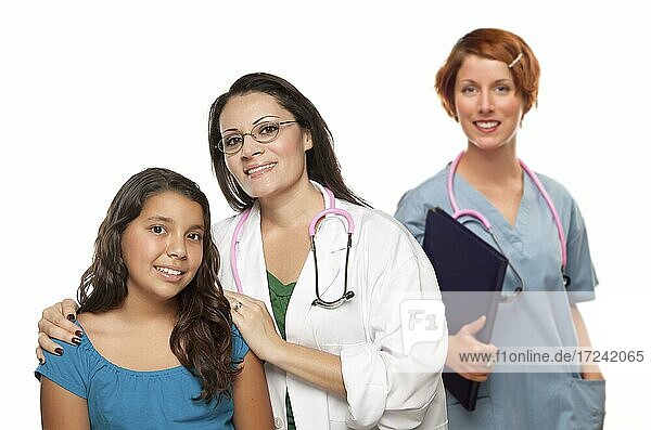 Pretty hispanic female doctor with child patient and colleague before a white background