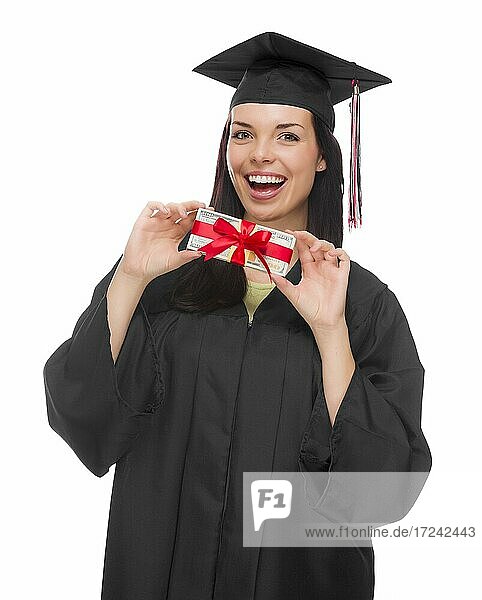 Glückliche weibliche Absolventin mit Kappe und Talar hält Geldgeschenk vor einem weißen Hintergrund