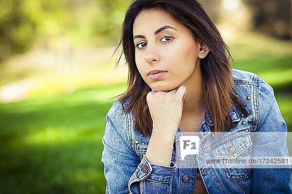 Beautiful mixed-race young woman portrait outside in the grass