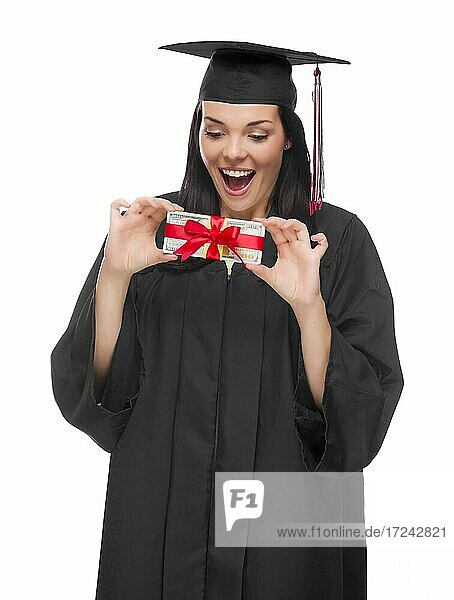 Happy female graduate in cap and gown holding stack of gift wrapped hundred dollar bills isolated on a white background
