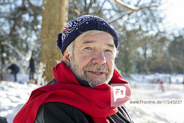 Senior man wearing red scarf during winter