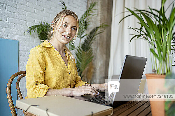 Female entrepreneur with laptop at home office