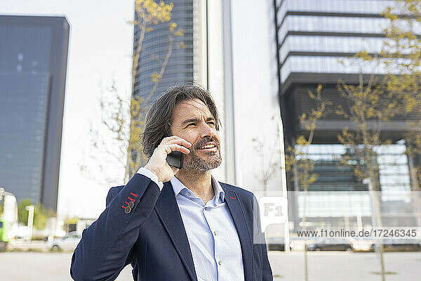 Male entrepreneur talking on mobile phone in city