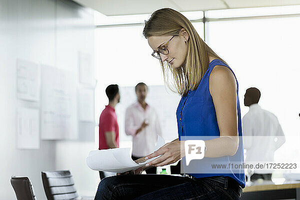 Businesswoman looking at document in office