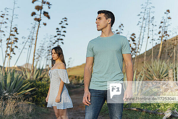 Couple standing at distant on footpath