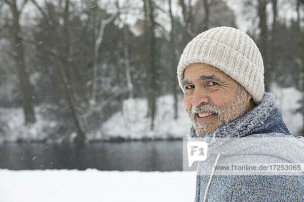 Smiling man wearing knit hat at park