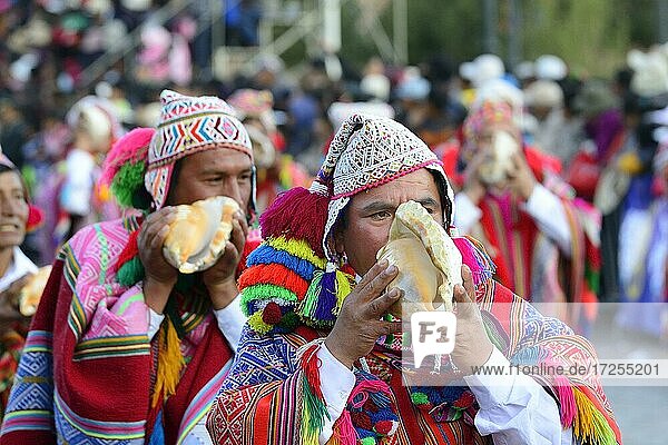 Indigener Mann bläst das Muschelhorn beim Umzug am Vortag von Inti Raymi  Fest der Sonne