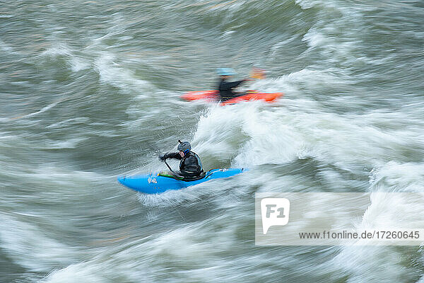 A kayaker surfs big standing waves of the Potomac River near Great Falls in his whitewater boat  Virginia  United States of America  North America