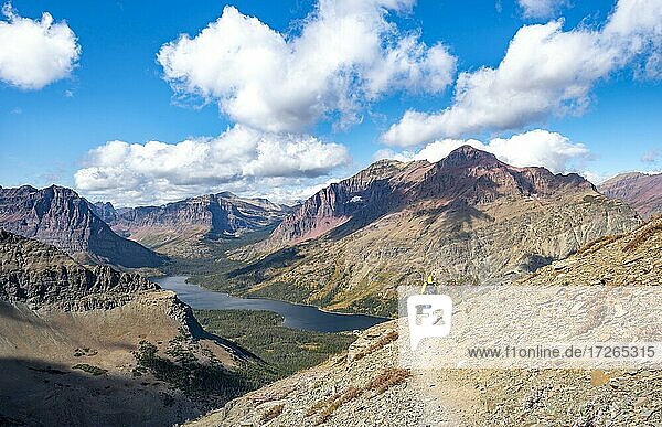 Hikers on the trail to Scenic Point  view of Two Medicine Lake with mountain peak Rising Wolf Mountain  Glacier National Park  Montana  USA  North America