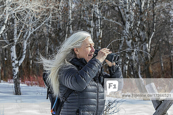 USA  Idaho  Bellevue  Senior woman using binoculars while hiking
