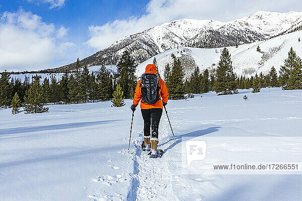 USA  Idaho  Sun Valley  Woman snowshoeing in mountains