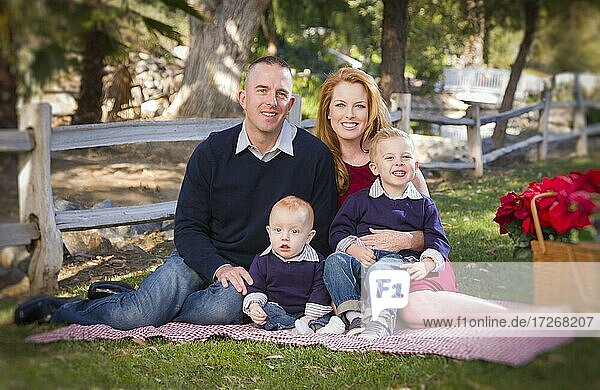 Beautiful small young family holiday portrait in the park