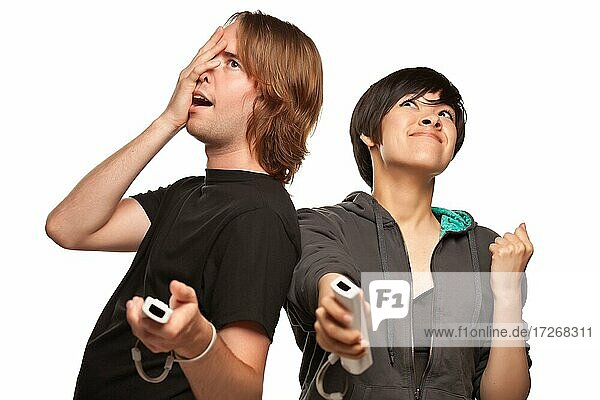 Fun happy mixed-race couple playing video game remotes isolated on a white background